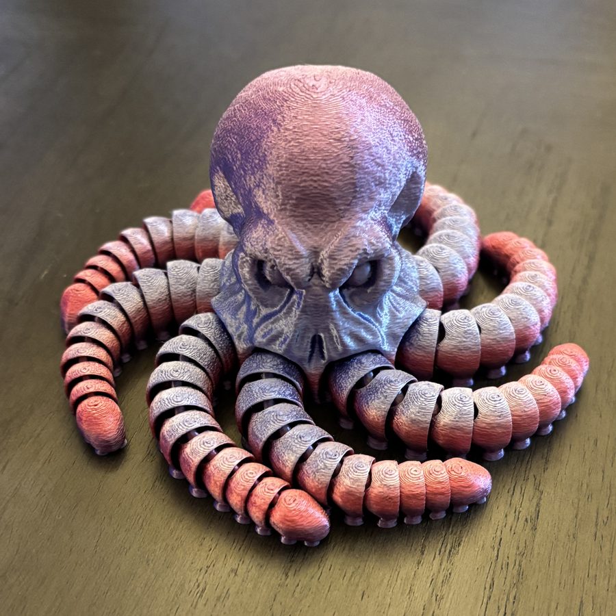 Articulated skull octopus 3D printed with color-shifting red and purple tentacles