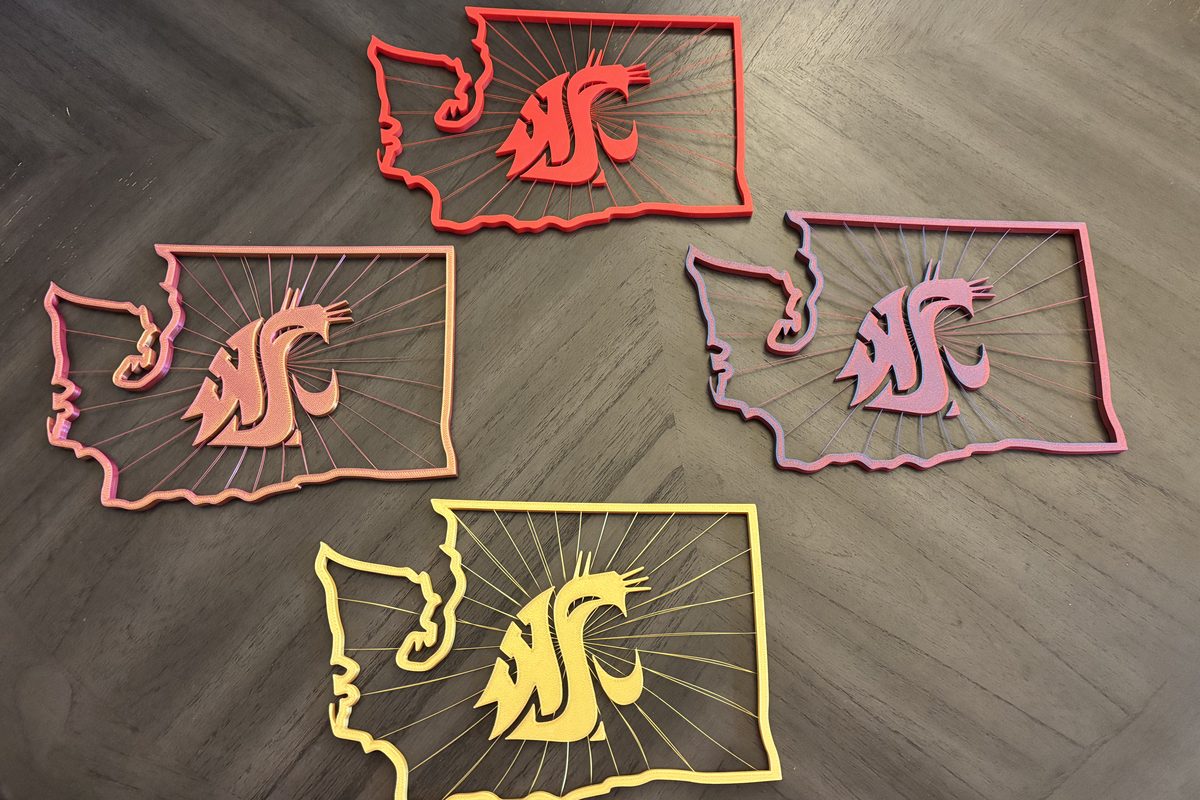 Four Washington State–shaped WSU Cougars wall signs 3D printed in red, coral, mauve and gold colorways
